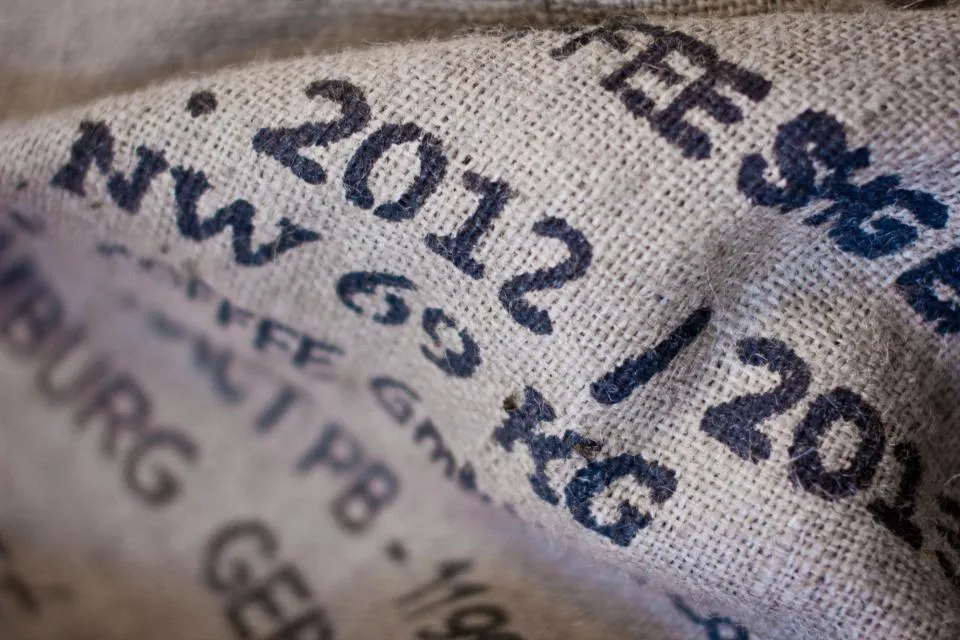 Close-up of a stencilled jute sack showing a weight marking